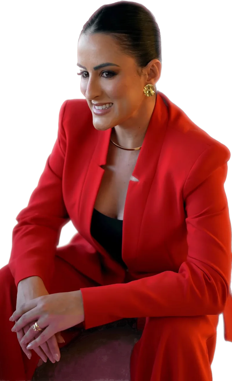 Dra. Mallu Cerutti sentada, inclinada para a frente, sorrindo